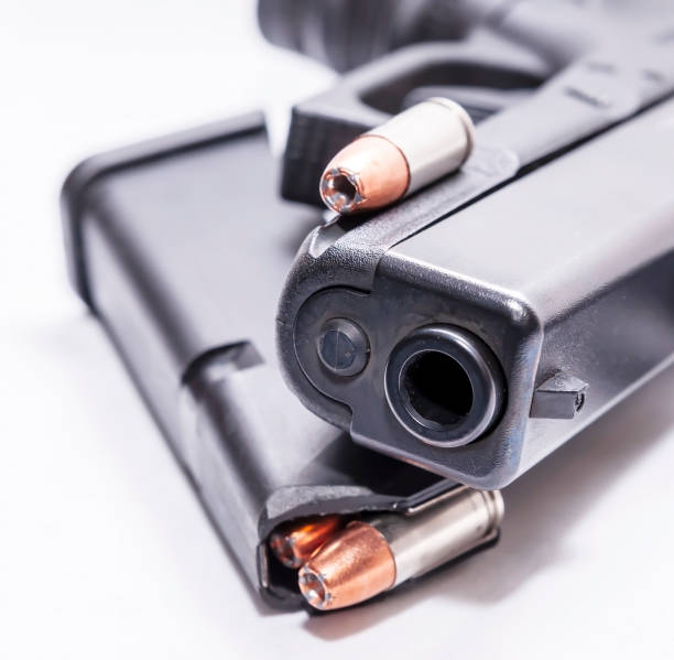 istock A black 9mm semi automatic pistol with a loaded pistol magazine with a single 9mm hollow point bullet 1201851707