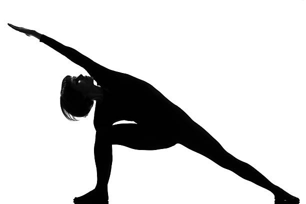 utthita parsvakonasana woman yoga pose woman yoga posture Extended Side Angle Pose position in silouhette on studio white background cat pose yoga stock pictures, royalty-free photos & images