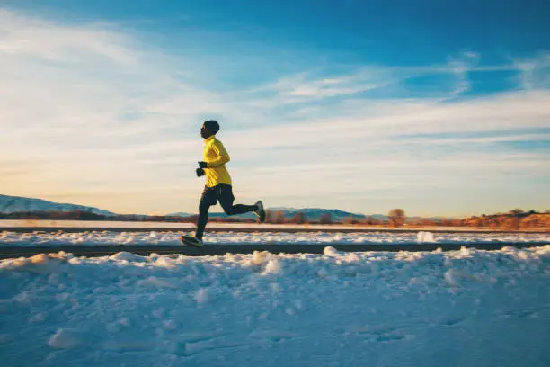 Photo of Adult Male Running During Winter Sunset