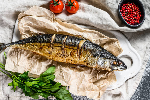 istock smoked mackerel with parsley and cherry tomatoes. Gray background. Top view 1201861810