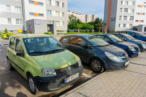 Poznan, Poland - May 24, 2019: Parked cars including a green Fiat Panda car on parking spots near by apartment buildings.