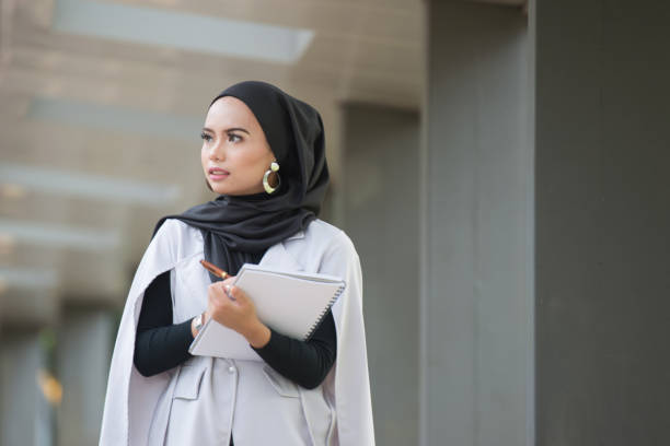 istock Malaysian young professional woman holding documents outdoor 1201865089