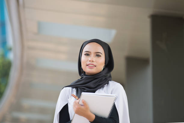 istock Malaysian young professional woman holding documents outdoor 1201865104