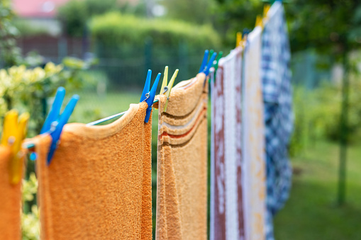 Washed laundry is hanging on clothesline outddors