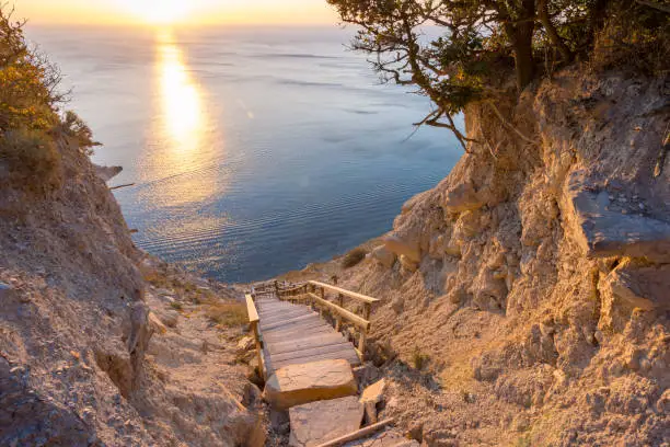 Landscape, a staircase from the mountain descends to the sea