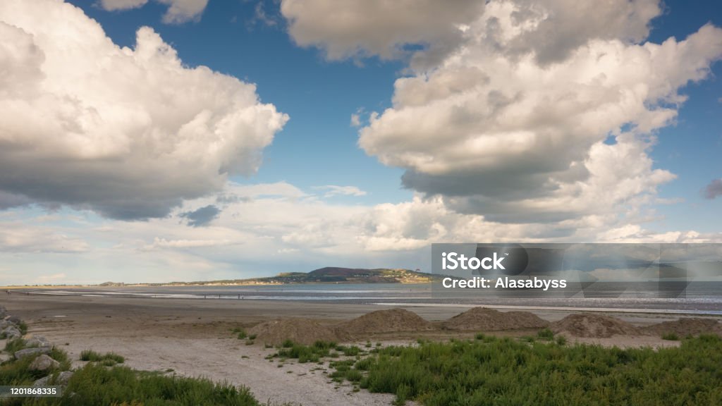 Dollymount Strand, Dublin, Ireland A dramatic cloudscape at Dollymount Strand in Dublin, Ireland. Howth Head can be seen in the distance. Beach Stock Photo