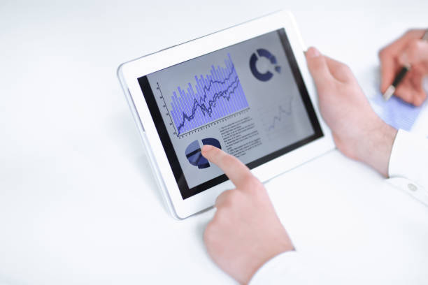 istock close up.businessman pointing with pen on a digital tablet screen. 1201869930