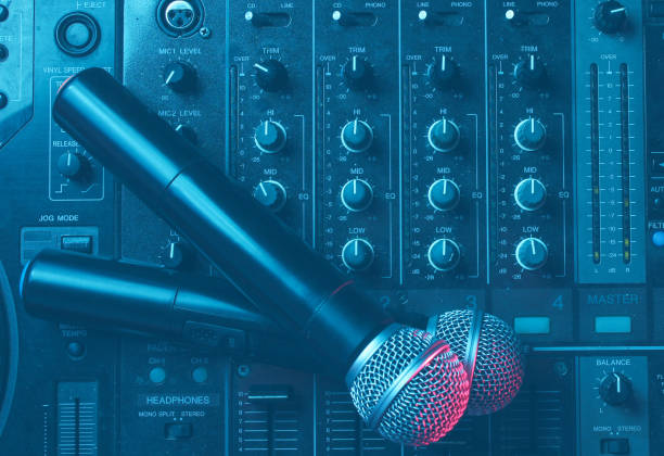 istock Night club, nightlife concept. Disco. Two microphone on DJ remote. Neon red blue light 1201872297