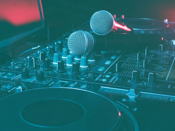 istock Night club, nightlife concept. Disco. Two microphone on DJ remote. Neon red blue light 1201872309