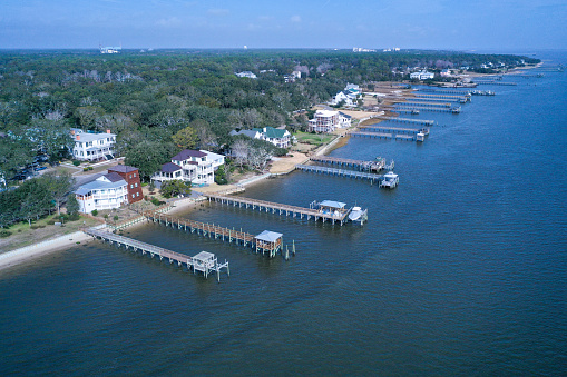 Aerial view looking at the docks along the waterfront at Southport NC. The string of boat docks line the Cape Fear river opening.
