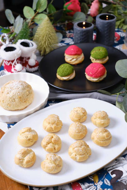 istock christmas choux cream or cream puff  with fresh cream set on cafe table. 1201873461