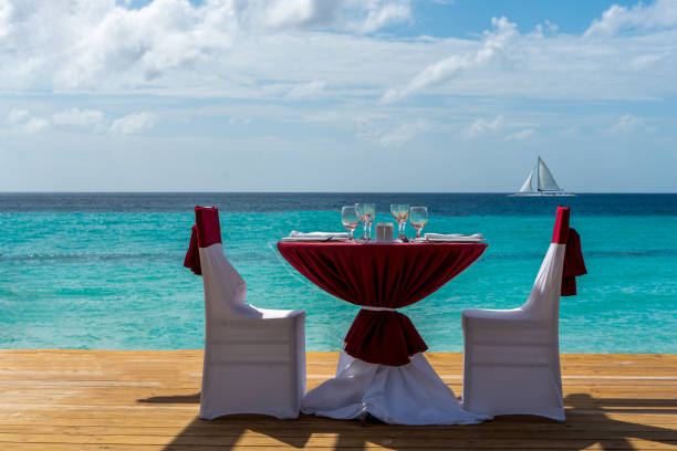 istock Festive table for two on a deck with a pergola by the sea 1201876276