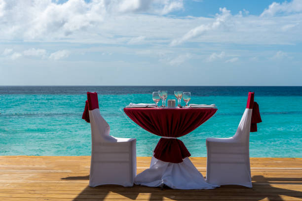 istock Festive table for two on the beach by the sea 1201876429