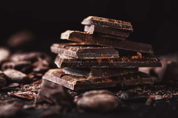 istock Closeup of dark chocolate chunks on table. 1201880075
