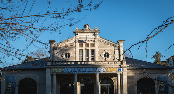 Montpellier, France - January 2, 2019: architectural detail of the popular pavilion (Pavillon Populaire) next to the Place de la Comedie where people pass on a winter day