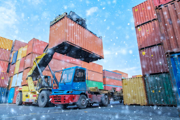 istock Crane lifting up container in a port. 1201882177