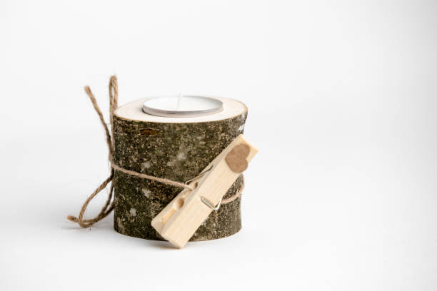 White candle with wodden decoration on white background it is a great gift.