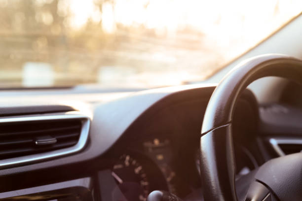 istock Car dashboard interior view of inside the vehicle including steering wheel dials and controls 1201888190