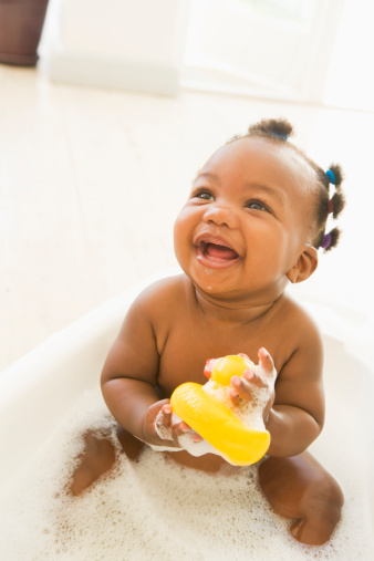 Smiling baby in bubble bath
