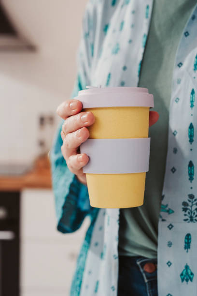 istock Woman holding to go take out coffee cup 1201889606