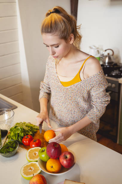 istock Concentrated young female person preparing healthy dinner 1201892043