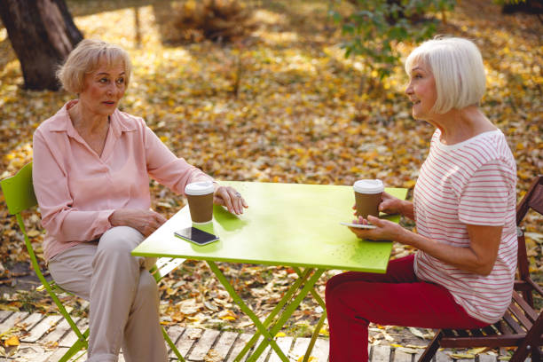 istock Two friends meeting over a cup of coffee 1201893392