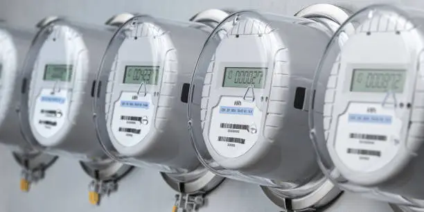 Photo of Digital electric meters in a row measuring power use. Electricity consumption concept.
