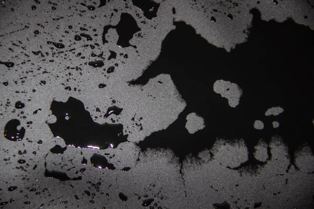 istock Horrible abstract background with drips of liquid. Black water flowing on dark background. Gloomy pattern from water for use in design. 1201894714