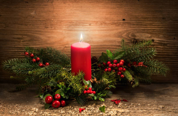 istock Burning Christmas red candle and festive Christmas decorations on rustic wooden table. Christmas advent 1201896247