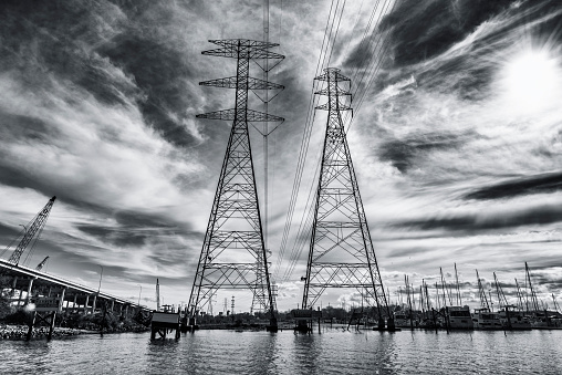 Large, high voltage power line pylons running across Clear Lake, Texas just south of Houston.