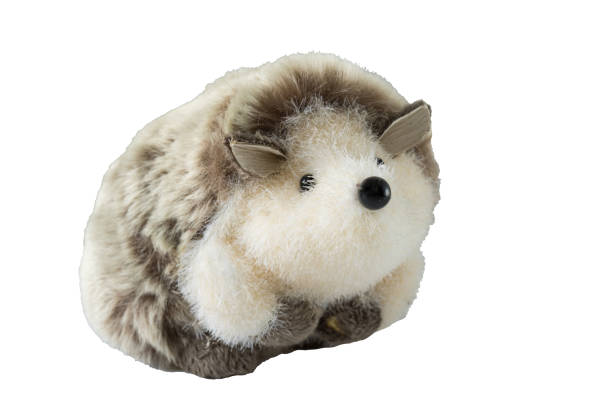 Soft toy grey sitting hedgehog stuffed with fluffy material isolated on white.