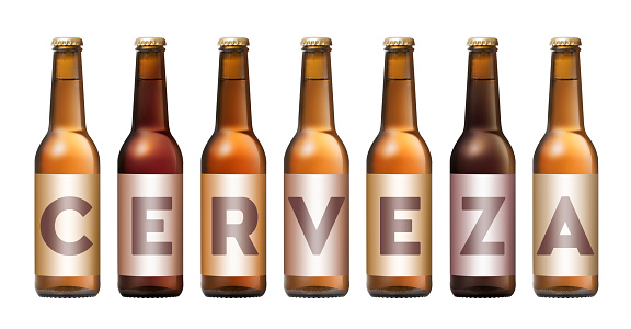 Bottles of beer forming word cerveza