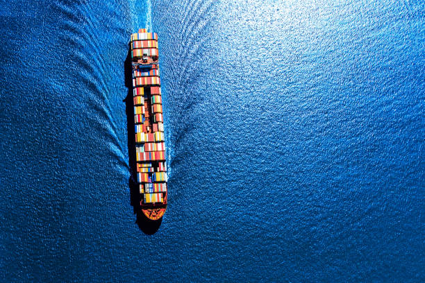 Fully Loaded Container Ship A fully loaded container ship heading toward the Port of Houston from the Gulf of Mexico. sea wake stock pictures, royalty-free photos & images