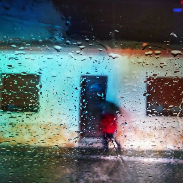 istock Raindrops at night, on car glass. 1201905566