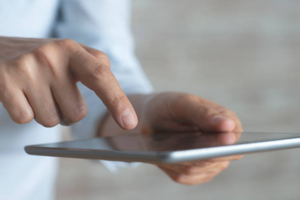 istock Woman Holding Digital Tablet 1201905655