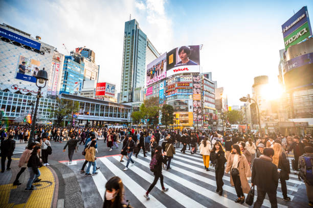 View Shibuya Crossing at sunset Tokyo 2020 Japan View Shibuya Crossing at sunset Tokyo 2020 Japan tokyo crowds on the famous shibuya crossing japan stock pictures, royalty-free photos & images