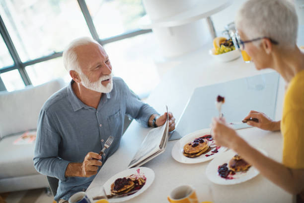 istock Mature couple having a breakfast at a kitchen counter. 1201906597