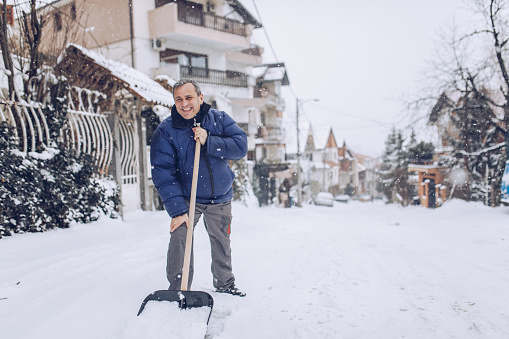 man with snow shovel, winter weather