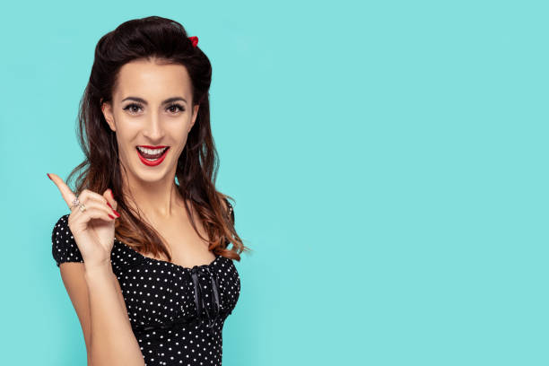 istock Pin-Up beautiful woman with an idea pose on turquoise background 1201911007