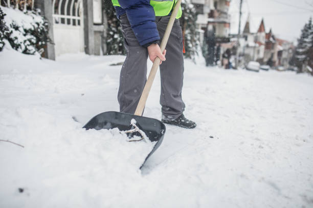 istock man with snow shovel, winter weather 1201911075