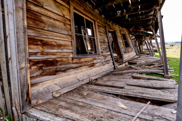 istock Broken down wooding western building with leaning walls falling down 1201911302