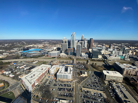 Charlotte, United States, January 6, 2020: Aerial view of downtown Charlotte, North Carolina showing Bank of America football stadium taken from a helicopter. Charlotte is the most populous city in North Carolina and the 16th in the United States. It is home to many banking corporation headquarters, which has made it the second largest banking center in the United States. It is home to the Carolina Panthers football team and the Charlotte Hornets basketball team, that play respectively at Bank of America Stadium, pictured here, and the Spectrum Center.