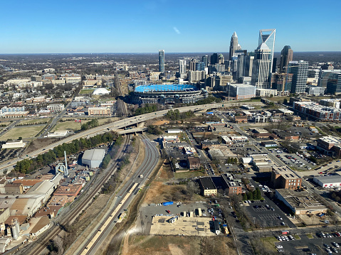 Charlotte, United States, January 6, 2020: Aerial view of downtown Charlotte, North Carolina showing Bank of America football stadium taken from a helicopter. Charlotte is the most populous city in North Carolina and the 16th in the United States. It is home to many banking corporation headquarters, which has made it the second largest banking center in the United States. It is home to the Carolina Panthers football team and the Charlotte Hornets basketball team, that play respectively at Bank of America Stadium, pictured here, and the Spectrum Center.