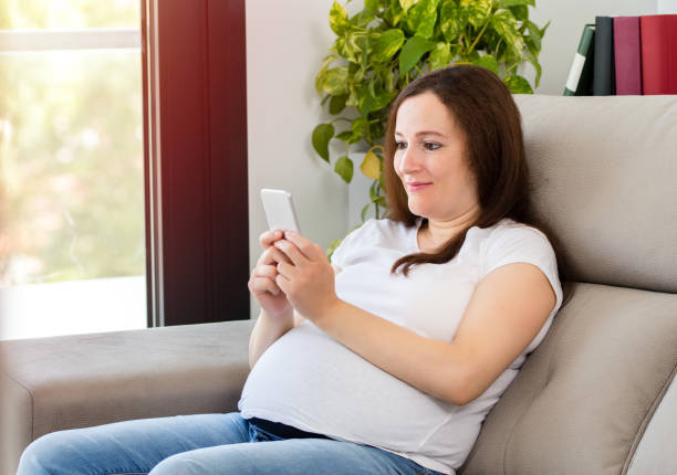 istock pregnant woman  checking mobile phone content 1201914838