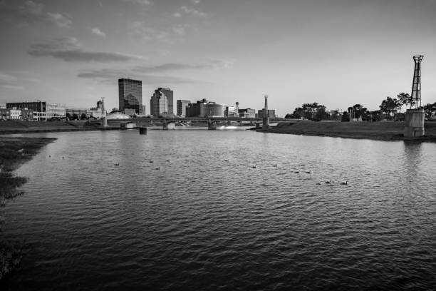 Waterfowl, River, and Downtown Dayton A black and white low aerial photo via drone over the confluence of the Great Miami and Mad River looking toward downtown Dayton with geese, ducks, and other waterfowl swimming on the river in front of the river fountains in the summer. dayton ohio skyline stock pictures, royalty-free photos & images