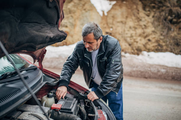 istock Car breakdown, driver standing by the car 1201916437