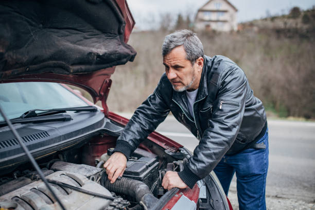 istock Car breakdown, driver standing by the car 1201916447