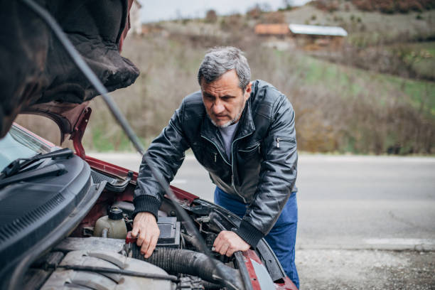 istock Car breakdown, driver standing by the car 1201916594