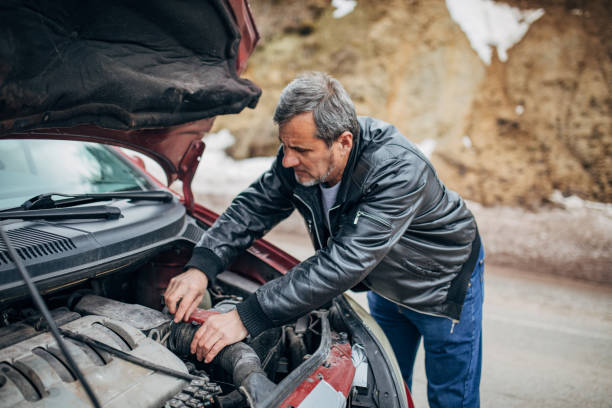 istock Car breakdown, driver standing by the car 1201916707