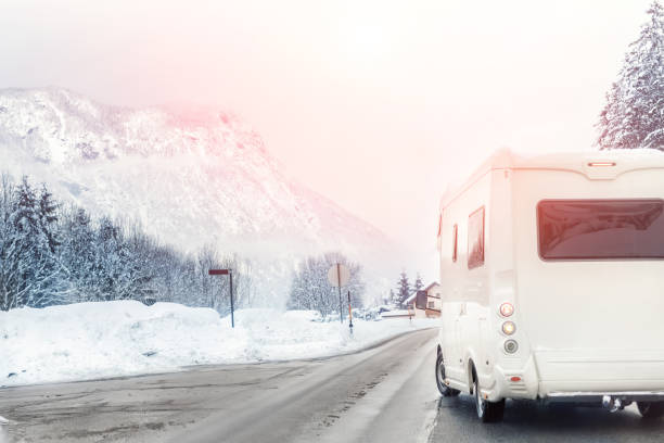istock Caravan or campervan turning from road with beautiful mountain alpine landscape on background at cold winter season.Family vacation travel, holiday trip in motorhome. Beautiful austrian nature scene 1201917639